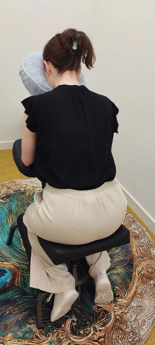 A client seated on the massage chair